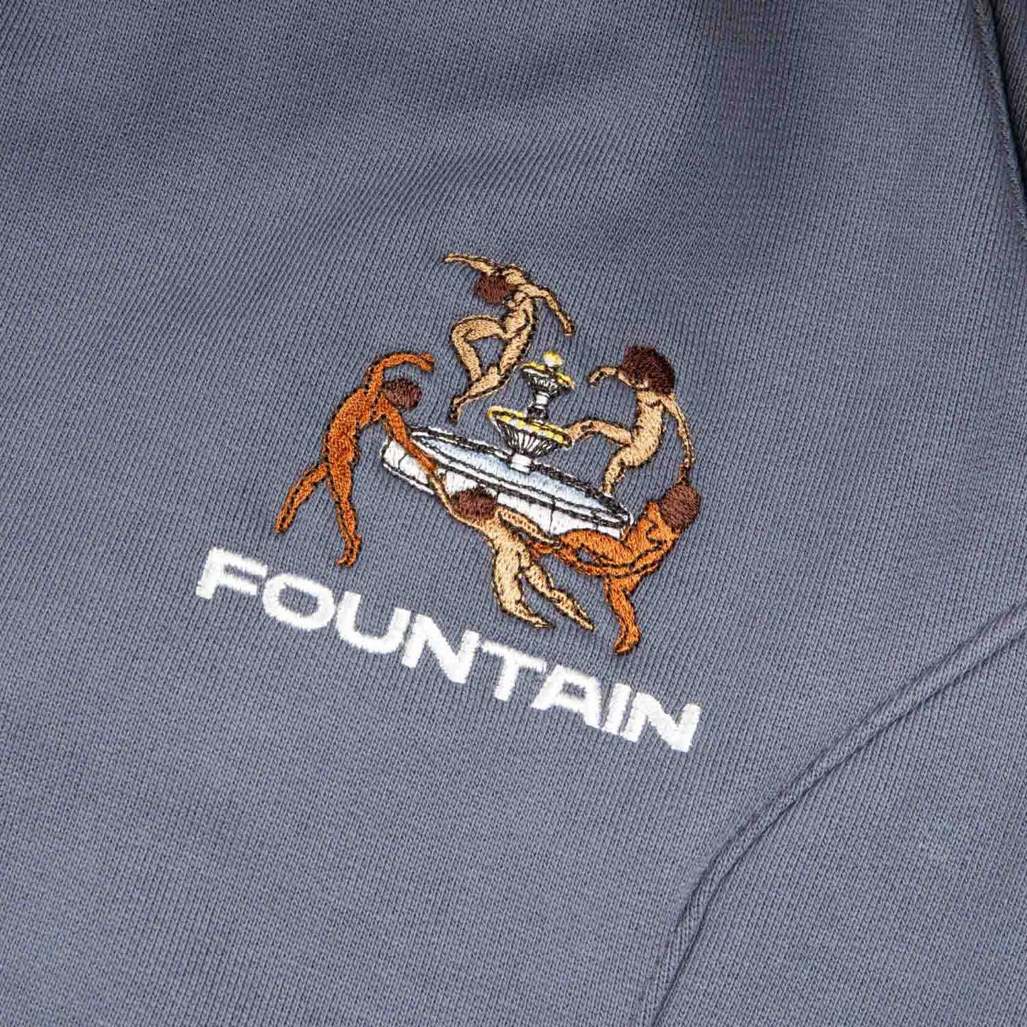 Close detail of the embroidered Liberation artwork at the left pocket