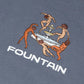 Close detail of the embroidered Liberation artwork at centre chest