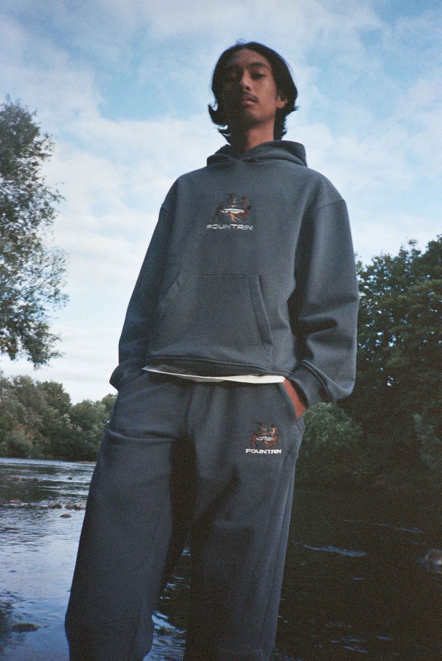 Don wearing the Liberation Tracksuit beside a river in Cardiff