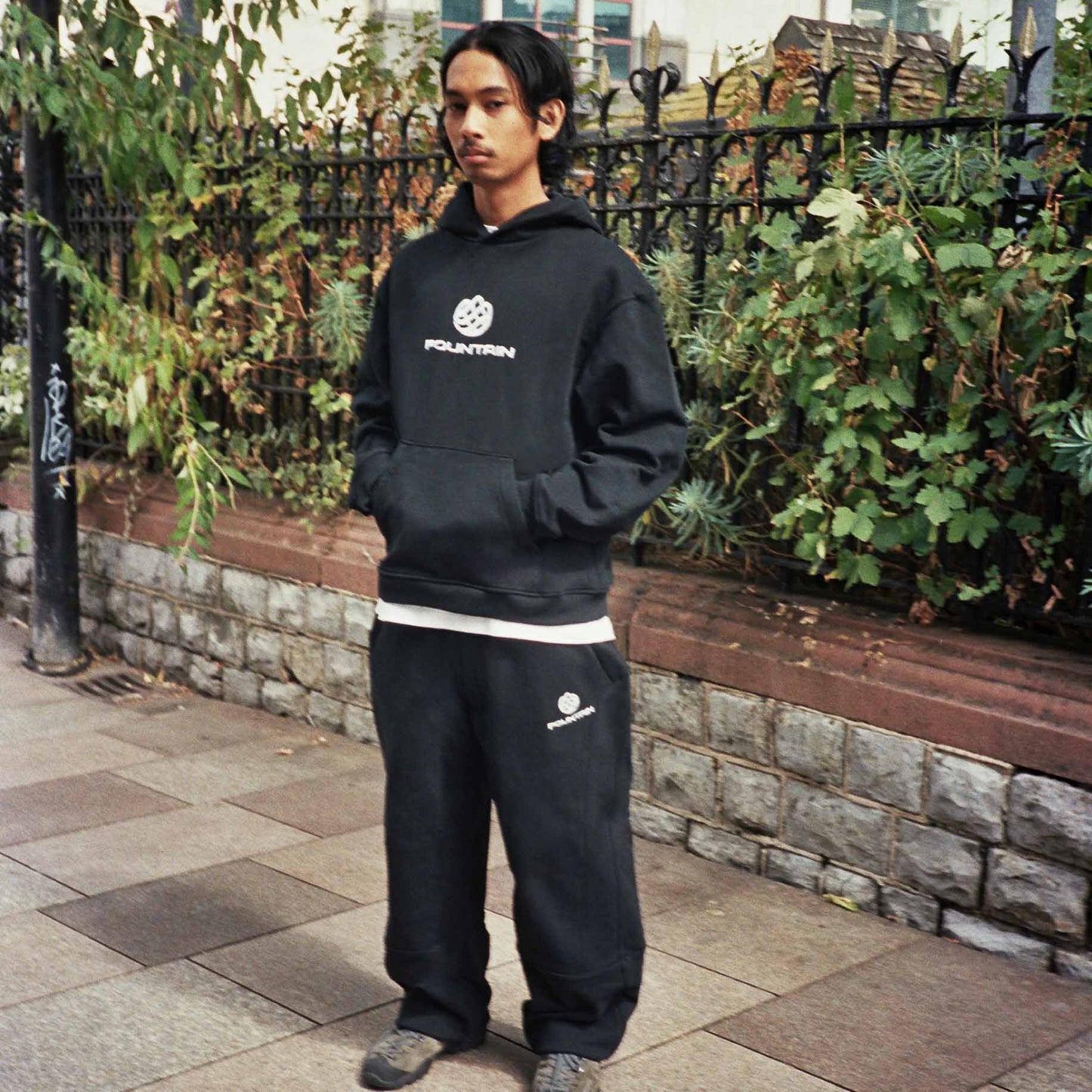 Don wearing the Monogram Tracksuit in black on a Cardiff street