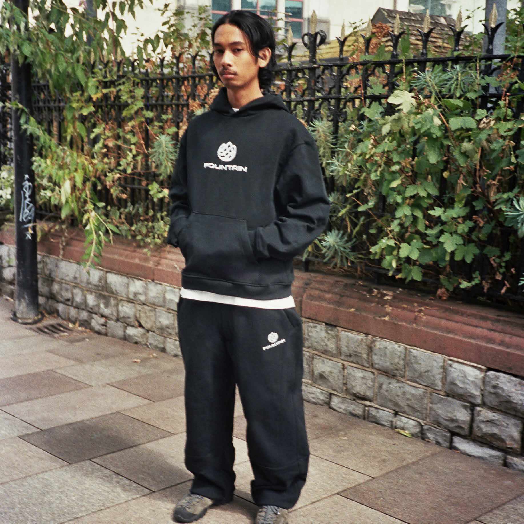Don wearing the Monogram Tracksuit in black on a Cardiff street
