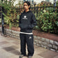 Don wearing the Monogram Tracksuit in black on a Cardiff street